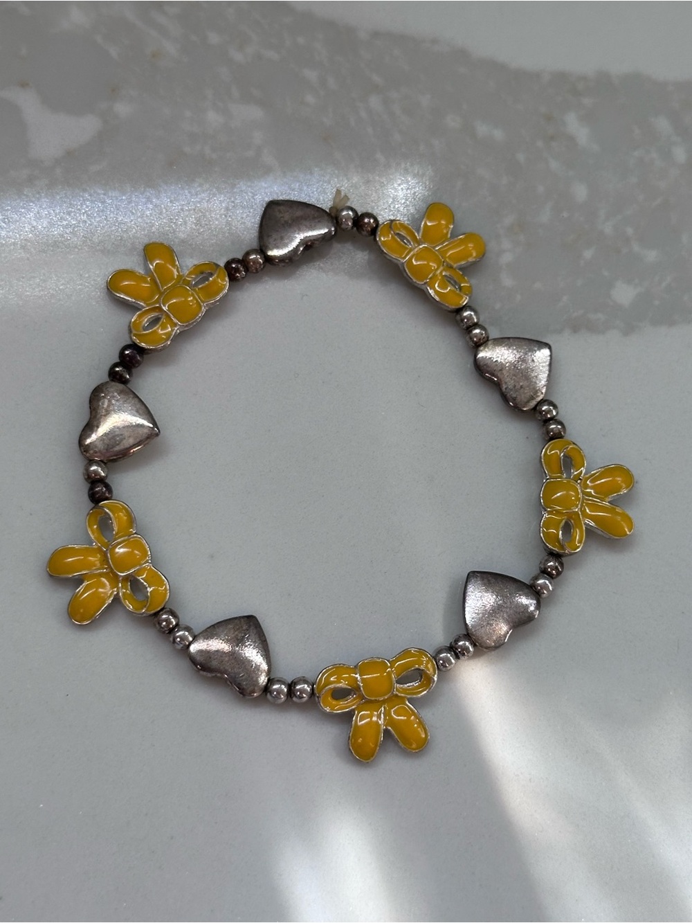 vintage yellow bow and silver heart bracelet